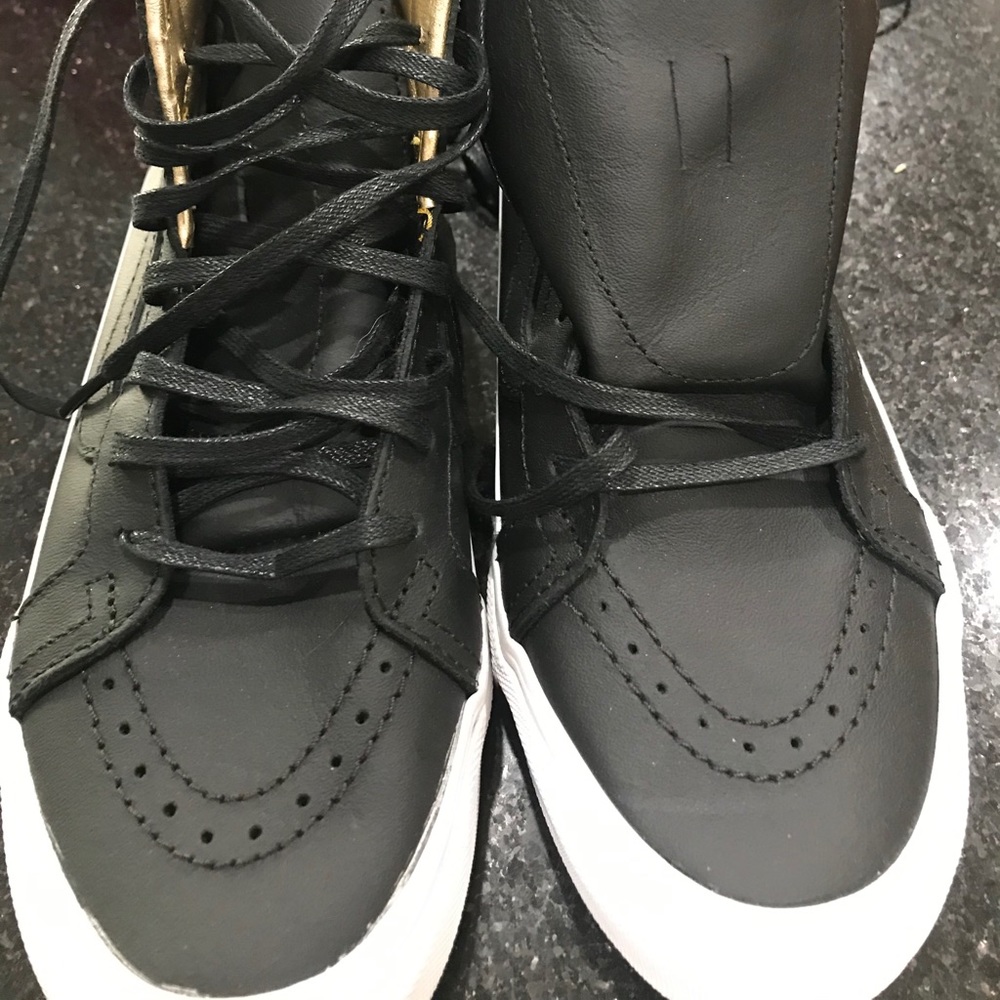 Women’s black leather Vans high tops size 7